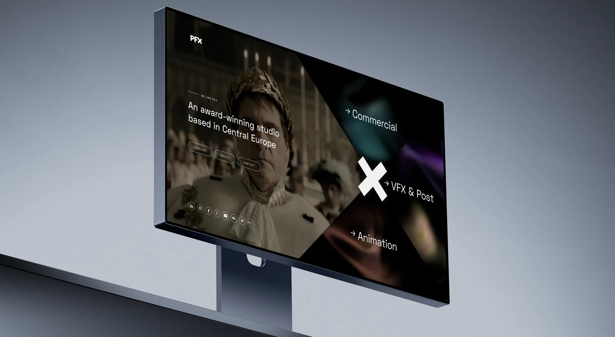 A desktop monitor at an angle showing the PFX homepage: a costumed film still behind the line “An award-winning studio based in Central Europe”, with angled panels for Commercial, VFX & Post and Animation.